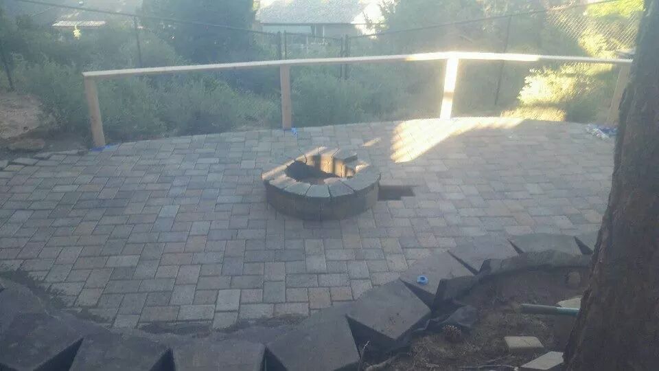 Retaining wall, paver patio with gas fire pit in center. We also installed the cable fencing and patio railings (2014)   